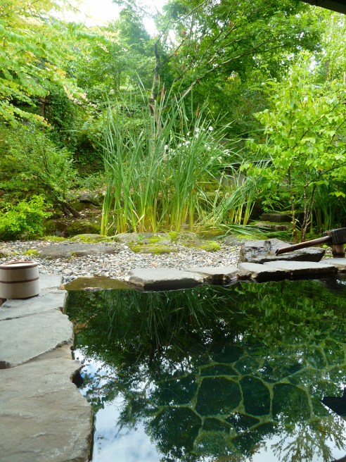 Beyond the sheer relaxation, sleeping on tatami mats, and the special food, a key reason to stay at a ryokan is their hot springs baths, called onsen.  This is a view of a private one.