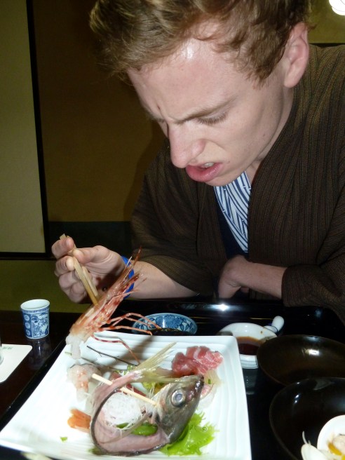 Here is Gray meeting dinner on the first of three nights.  I knew then we were booked for two nights too many, in his estimation.  Over the next day he started periodically measuring his wrist circumference as a  proxy for his starvation level.  It's not that there wasn't massive quantities of food.  He just could not get his bearings with virtually everything but rice being unfamiliar, small, often cold, often pickled or raw.  Or in this case, extremely artfully displayed to look like it was still au naturel.