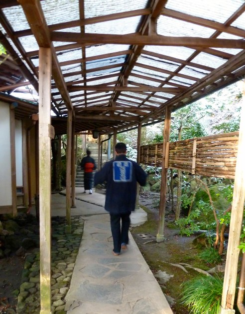 Some of the accommodation is reached by covered foot paths.  These are two workers delivering early morning breakfast courses.