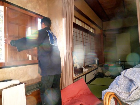 The biggest thing you have to get used to in a ryokan is the staff coming in your room nearly at will.  Here is our twice daily visitor who handled the wooden window shutters.