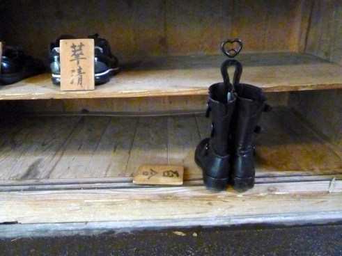 Here are my boots, carefully labeled with what?  My room name?  My name?  My description:  "silly American woman with yellow hair and giant yellow hair son"?