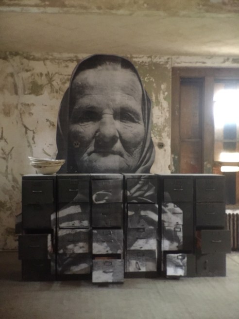 The French artist JR has masterfully applied actual photos of Ellis Island immigrants onto the decaying surfaces. I loved the story about this woman. When she met a US official he asked her a standard question to test her mental acuity. "If you are hired to clean stairs, is it correct to start cleaning at the top or the bottom." This feisty person answered, "Sir, I did not come to America to clean stairs." She passed the test with flying colors.